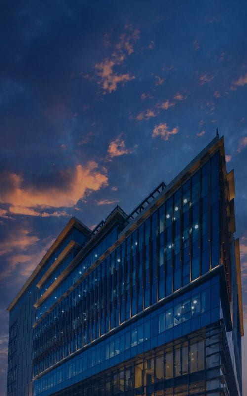 Manipal Hospital building exterior at dusk