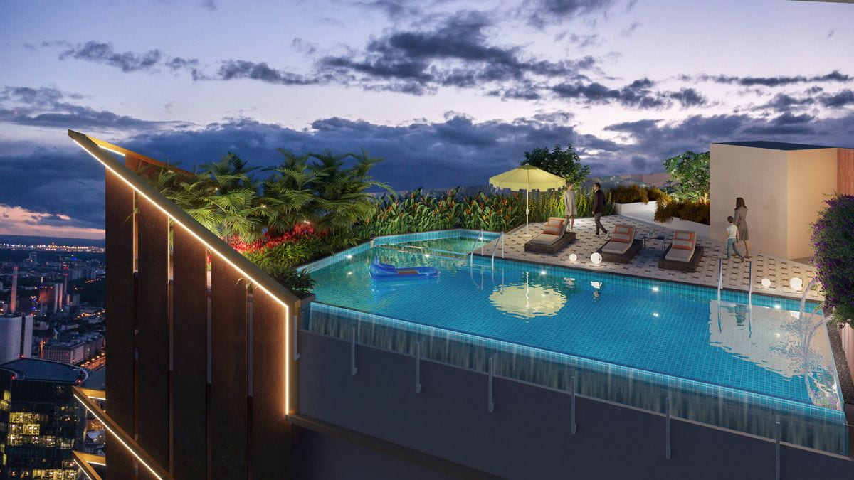 Rooftop infinity pool at Vaishnavi Premiere lit up at night