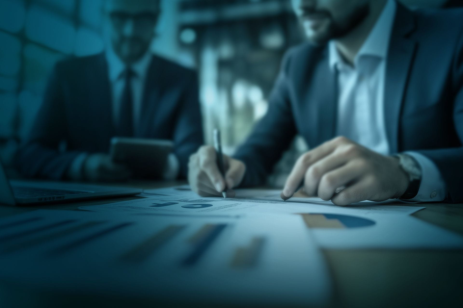 Close-up of hands signing a document