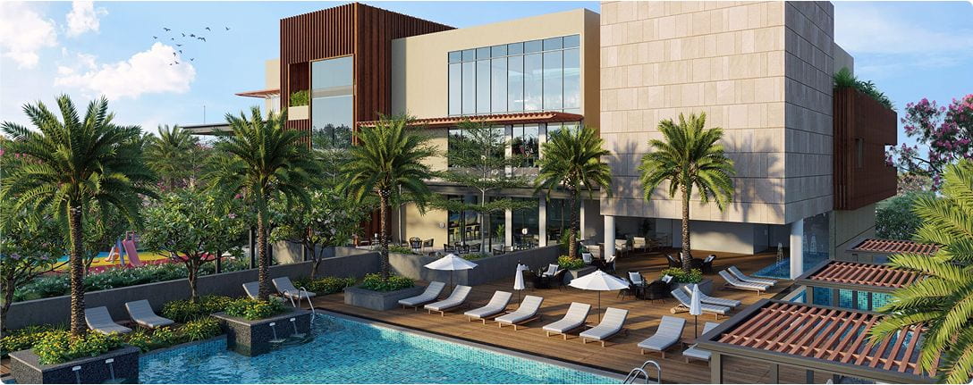 Aerial view of Vaishnavi Life residential complex with pool and palm trees